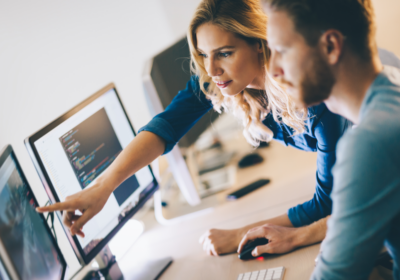 woman and man looking at a computer