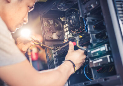 man fixing a desktop computer